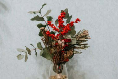 Güzel bir Noel ya da yeni yıl buketi Viburnum, Ilex ve brunia meyveleri. Çiçek düzenleme, çiçekçilik ve çiçek dekoru..
