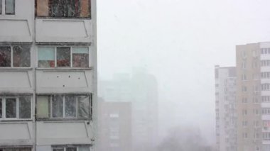 Kış mevsiminde şehir manzarası. Dondurucu havada yağan kar taneleriyle birlikte kar yağışı. Aralık, Ocak, Şubat. Çok katlı bina..