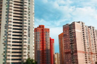 Kyiv, Ukrayna. 7 Haziran 2025 Bulutlu bir gökyüzüne karşı bir grup bina şehir manzarası yaratıyor. Gökyüzünün altında birçok penceresi olan uzun bir apartman. Arka planda başka binalar da görünüyor..