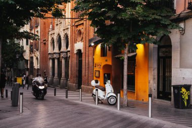 Madrid, İspanya 1 Haziran 2024 Charming Avrupa sokak ve mimari ayrıntıları. Vespa scooter 'ı, motosikleti ve tarihi mimarisi olan samimi bir sokak sahnesi..