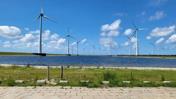 Offshore windmill farm in the ocean Westermeer wind farm, windmills isolated at sea on a beautiful bright day Netherlands Flevoland Noordoostpolder. Huge windmill turbines