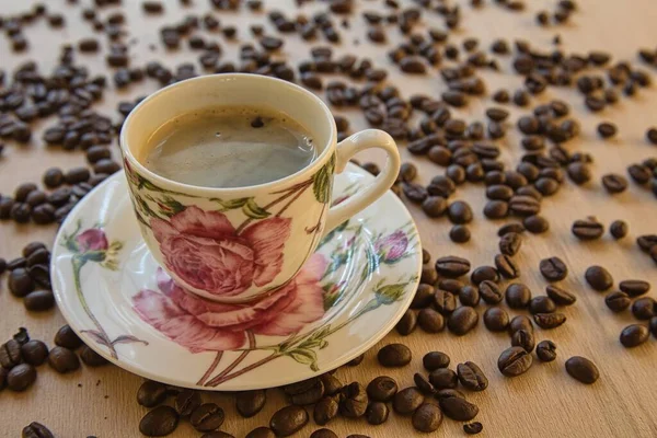 来杯热咖啡 背景是咖啡豆 免版税图库照片