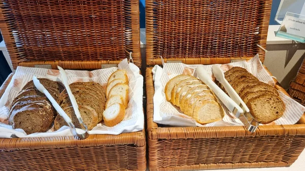 Bread in a basket at a breakfast buffet in a luxury hotel.