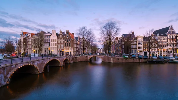 Amsterdam Netherlands canals during sunset with lights in the evening in December during wintertime in the Netherlands Amsterdam city. Europe.