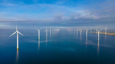 Denizdeki yel değirmeni türbinleri Hollanda 'daki büyük bir yel değirmeni parkında yukarıdan insansız hava aracı görüntüsü ile görülüyor.