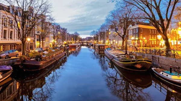 stock image Amsterdam Netherlands canals with lights during the evening in December during wintertime in the Netherlands Amsterdam 