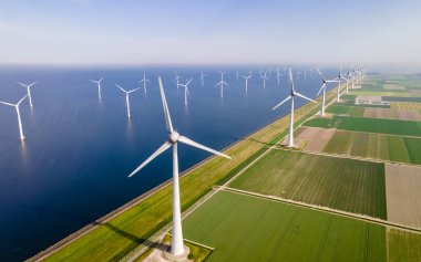 windmills turbines and a blue sky, green energy windmill turbines generating electric clipart