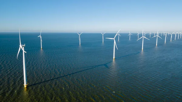 stock image Aerial view at Windmill park with wind mill turbines generating electricity with a blue sky green energy concept