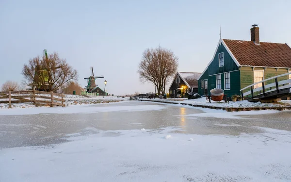 Windmill village during winter with snow in the Netherlands Holland Zaanse Schans village in winter