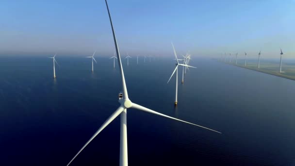 雲と青い空を持つオフショア風車公園 風力タービンフレヴォランドオランダIjsselmeerと海の空中ビューで風車 緑のエネルギー — ストック動画