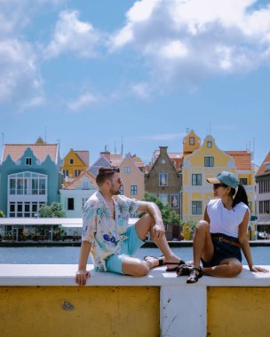 Curacao, Hollanda Antilleri mutlu bir çift Asyalı kadın ve Kafkasyalı erkek Curacao 'yu ziyaret ediyor, Willemstad Curacao Karayip Adası şehir merkezindeki renkli binaları.