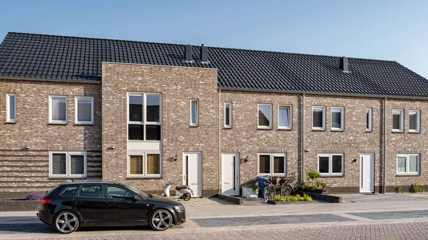 Newly build houses with solar panels attached on the roof against a sunny sky, housing market in the Netherlands
