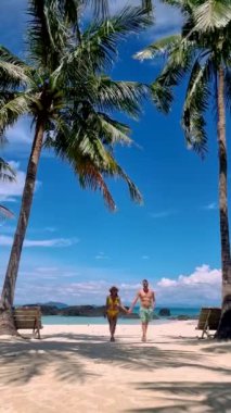 Couple of men and women on a trip to the Tropical Island Koh Kham in the Koh Chang archipelago of Trat Thailand. 