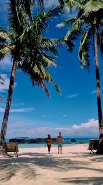 Couple of men and women on a trip to the Tropical Island Koh Kham in the Koh Chang archipelago of Trat Thailand. 