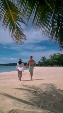 Couple of men and women on a trip to the Tropical Island Koh Kham in the Koh Chang archipelago of Trat Thailand. 