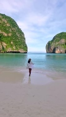 Asian Thai women walking at the beach on the Tropical Island of Koh Phi Phi Thailand. 