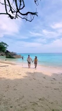 Couple relaxing on the beach of the Tropical Island Similan in Southern Thailand. 