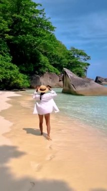 Asian women walking on the beach of the Tropical Island Similan in Southern Thailand.