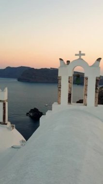 Sunset at the village of Oia Santorini whit a greek church at sunset in Greece Santorini.