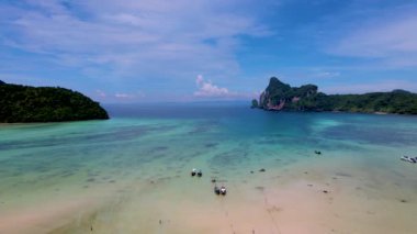 view of the turqouse colored ocean with longtail boats at Koh Phi Phi Don Thailand. 