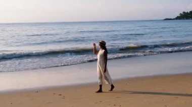Asian women walking on the beach during sunset in Phuket Thailand.
