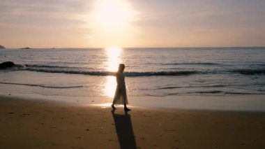 Asian women walking on the beach during sunset in Phuket Thailand.