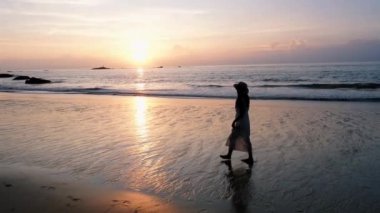 Asian women walking on the beach during sunset in Phuket Thailand.