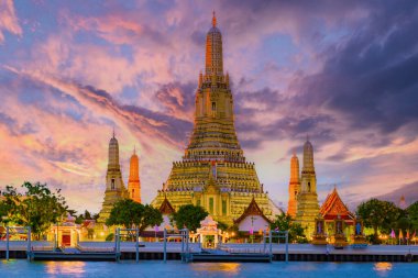 Wat Arun temple Bangkok during sunset in Thailand. Chao praya river