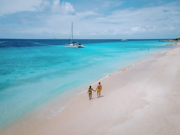 stock image Small Curacao Island famous for day trips and snorkeling tours on white beaches and blue clear ocean, Curacao Island in the Caribbean sea. a couple of men and woman on the beach during a vacation 