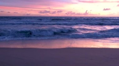 Sunset on the beach of Phuket Thailand with beautiful sky pink orange colors. 