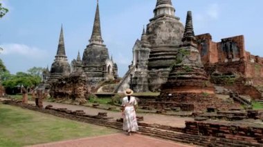 Women visit the Old ruins and Pagodas at Wat Chaiwatthanaram Temple of Ayutthaya Province. Ayutthaya Historical Park, Thailand. 