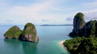 Aerial drone view of the limestone cliffs and tropical beach of Railay Beach Krabi Thailand at sunrise 