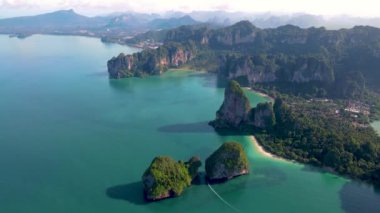 Aerial drone view of the limestone cliffs and tropical beach of Railay Beach Krabi Thailand at sunrise 