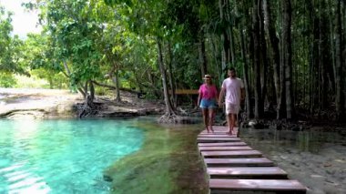 A couple of men and women visiting Emerald pool Krabi Thailand, and Blue pool Krabi during a vacation in Krabi Thailand