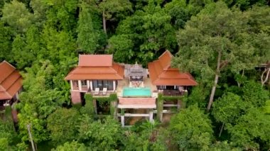 couple of men and woman on a luxury vacation at a pool villa in the rainforest jungle mountains
