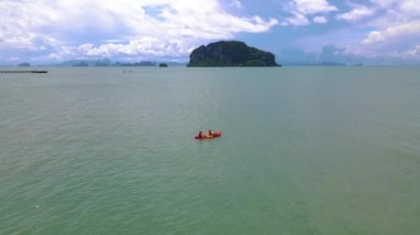 a couple of men and women in a kayak at the mangrove forest in Phuket Thailand. men and women paddling in a kayak during vacation