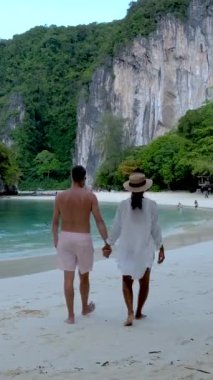 couple of men and women on a tropical white beach in Thailand, Koh Hong Island Krabi during summer vacation in Thailand