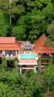 couple of men and woman on a luxury vacation at a pool villa in the rainforest jungle mountains