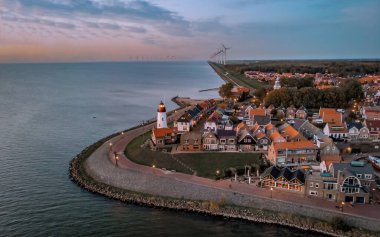 Urk Flevoland Netherlands sunset at the lighthouse and harbor of Urk Holland. Traditional Fishing village Urk. Beautiful sunset during the evening