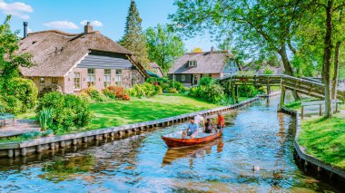 GIETHOORN, NETHERLANDS May 2020 view of typical houses in Giethoorn, The Netherlands. The beautiful houses and gardening city is known as Venice of the North in Europe