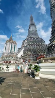 Couple at Wat Arun temple in Bangkok Thailand on a sunny day. 