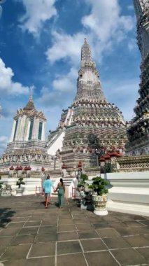 Couple at Wat Arun temple in Bangkok Thailand on a sunny day. 