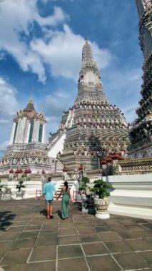 Couple at Wat Arun temple in Bangkok Thailand on a sunny day. 