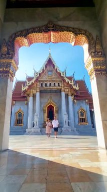 men and women visit Wat Benchamabophit temple in Bangkok Thailand, The Marble temple in Bangkok. 