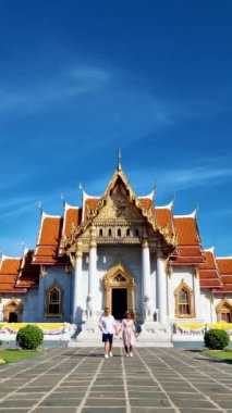 A couple of men and women visit Wat Benchamabophit temple in Bangkok Thailand, The Marble temple in Bangkok. 