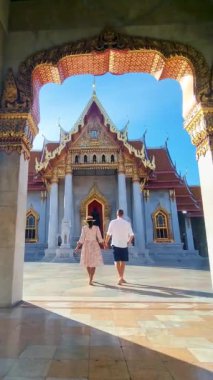 men and women visit Wat Benchamabophit temple in Bangkok Thailand, The Marble temple in Bangkok. 