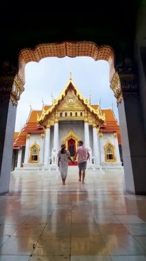 men and women visit Wat Benchamabophit temple in Bangkok Thailand, The Marble temple in Bangkok. 