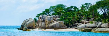 white tropical beach with huge boulders and palm trees Coco Island Tropical Seychelles Islands. 