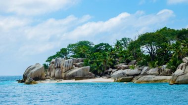 white tropical beach with huge boulders and palm trees Coco Island Tropical Seychelles Islands. 
