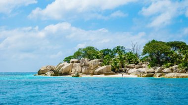 white tropical beach with huge boulders and palm trees Coco Island Tropical Seychelles Islands. 